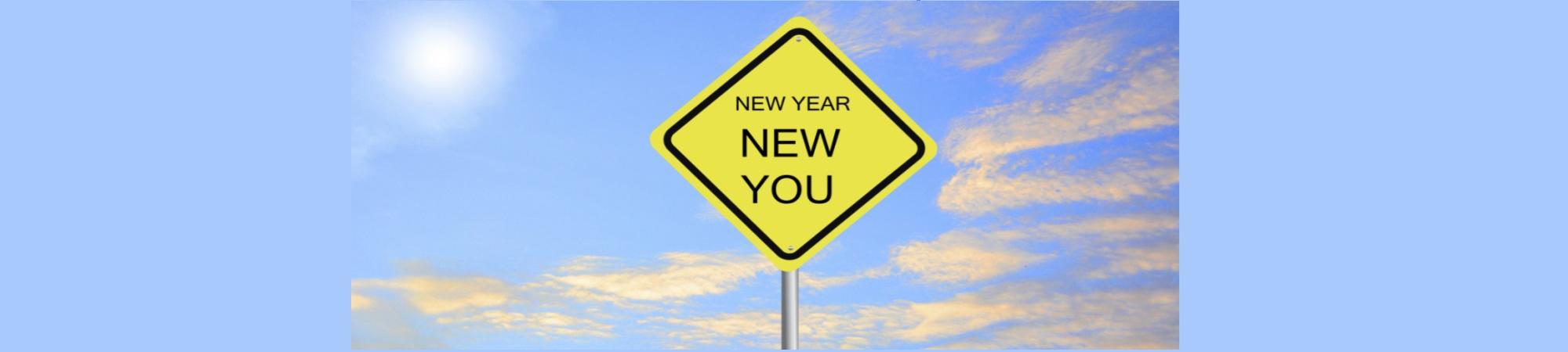 A yellow diamond-shaped traffic sign. Caution. It's a New Year and a New You. 