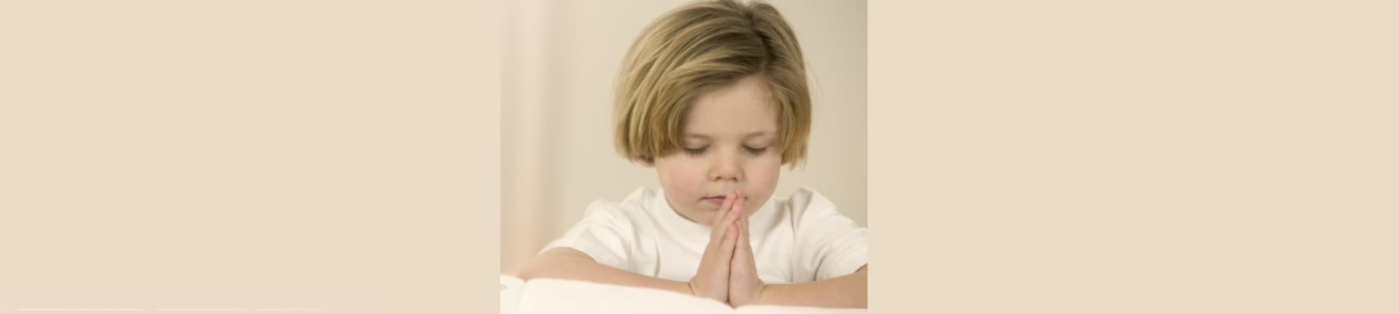 3-year-old girl in praying position. Soft pink. 